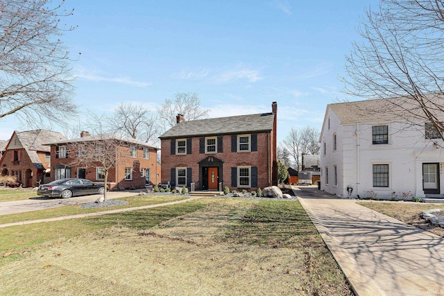 4707 Old Mill Rd, Fort Wayne, IN 46807 - view of front of property with brick siding, a chimney, a front lawn, and concrete driveway