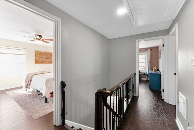 4707 Old Mill Rd, Fort Wayne, IN 46807 - hallway with an upstairs landing, dark wood-style floors, baseboards, and attic access