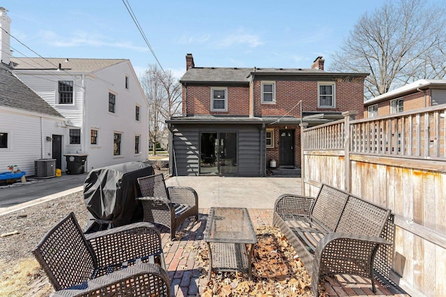 4707 Old Mill Rd, Fort Wayne, IN 46807 - rear view of house with brick siding, a chimney, a patio area, and central AC