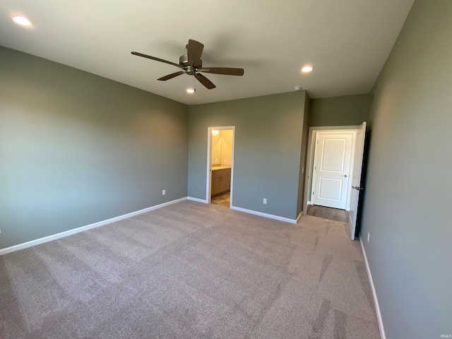 unfurnished bedroom with baseboards, ceiling fan, recessed lighting, ensuite bath, and light carpet