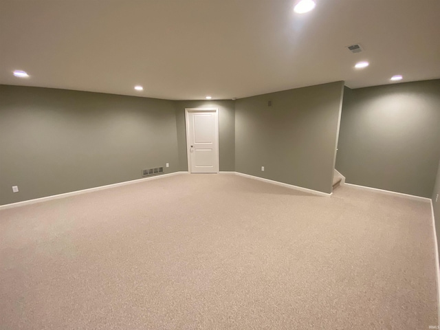 finished basement featuring light carpet, recessed lighting, visible vents, and baseboards