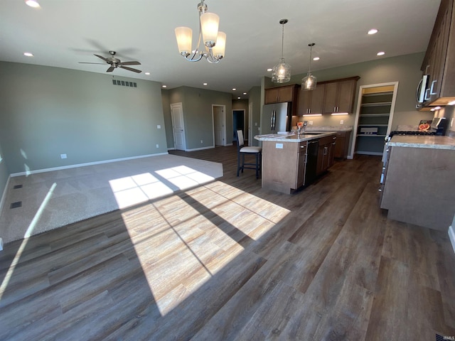 kitchen featuring visible vents, a kitchen island with sink, recessed lighting, ceiling fan with notable chandelier, and stainless steel appliances