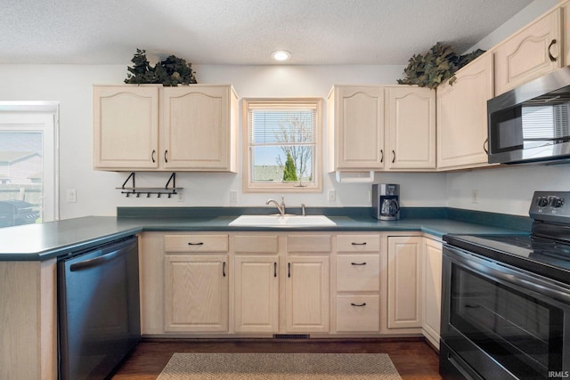 kitchen featuring a textured ceiling, stainless steel microwave, a sink, electric stove, and dishwasher