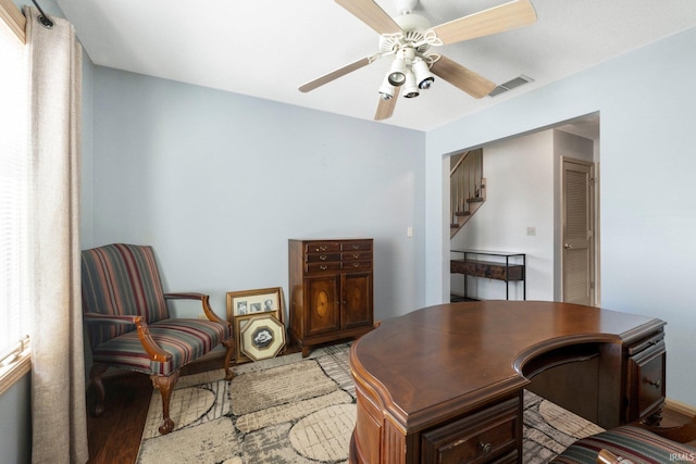 office space with visible vents, wood finished floors, and a ceiling fan