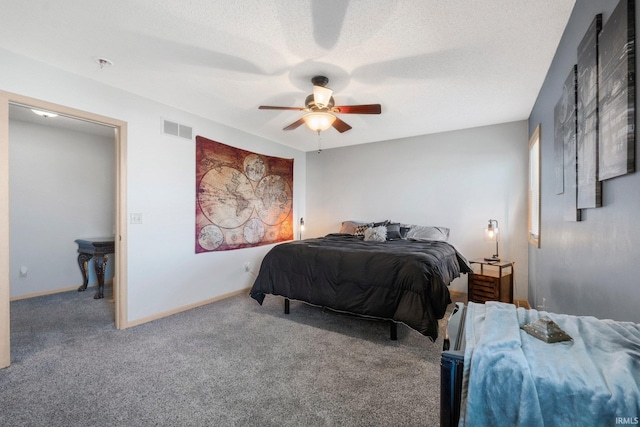 carpeted bedroom with visible vents, a ceiling fan, and baseboards