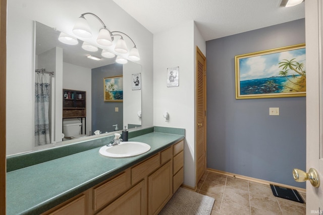 bathroom with vanity, toilet, visible vents, baseboards, and tile patterned flooring