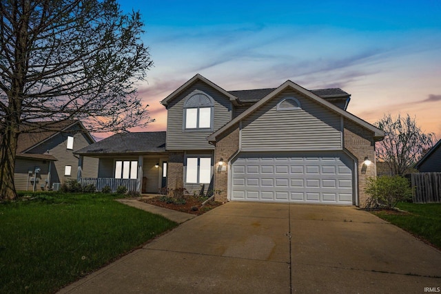 traditional-style home featuring concrete driveway, a front yard, brick siding, and a garage