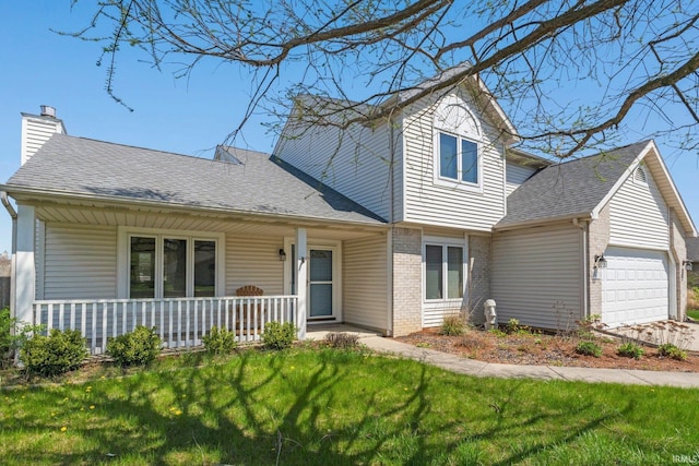 traditional home featuring a front yard, an attached garage, a porch, and brick siding