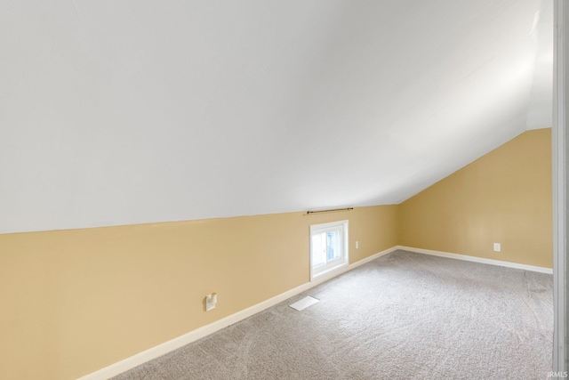 604 Short St, Decatur, IN 46733 - additional living space with lofted ceiling, visible vents, carpet floors, and baseboards