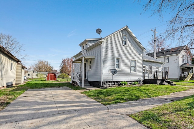 604 Short St, Decatur, IN 46733 - view of side of property with an outdoor structure, a yard, and a shed