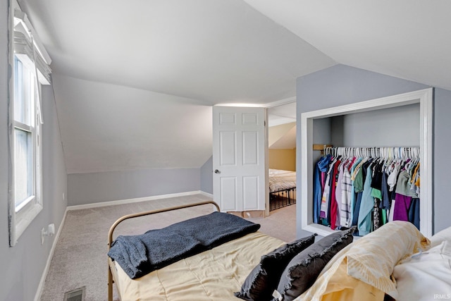 604 Short St, Decatur, IN 46733 - carpeted bedroom featuring lofted ceiling, baseboards, visible vents, and a closet
