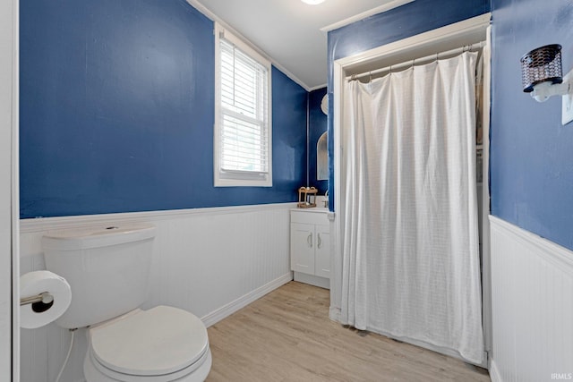 604 Short St, Decatur, IN 46733 - full bathroom with a shower with curtain, a wainscoted wall, wood finished floors, and toilet
