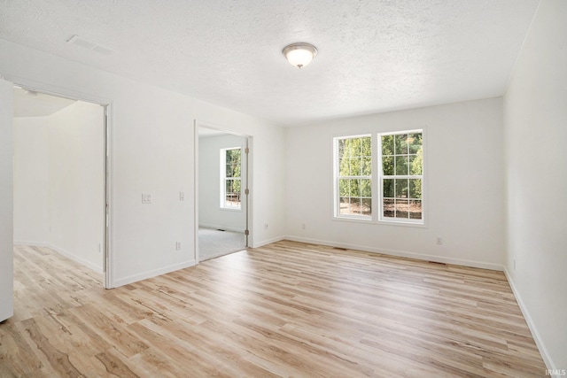 52773 County Road 29, Bristol, IN 46507 - empty room featuring visible vents, light wood-style flooring, baseboards, and a textured ceiling