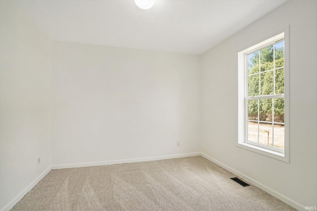 52773 County Road 29, Bristol, IN 46507 - spare room featuring visible vents, baseboards, light colored carpet, and a healthy amount of sunlight