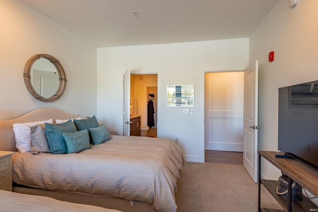 304 W Kirkwood Ave Unit 305, Bloomington, IN 47404 - bedroom with light carpet, ensuite bathroom, and baseboards