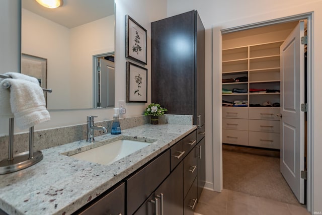 304 W Kirkwood Ave Unit 305, Bloomington, IN 47404 - bathroom with vanity, a spacious closet, and tile patterned flooring