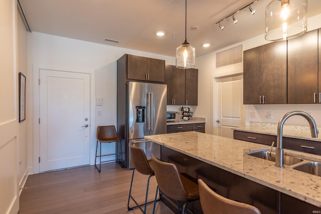304 W Kirkwood Ave Unit 305, Bloomington, IN 47404 - kitchen featuring high end fridge, dark brown cabinets, visible vents, dark wood finished floors, and a sink