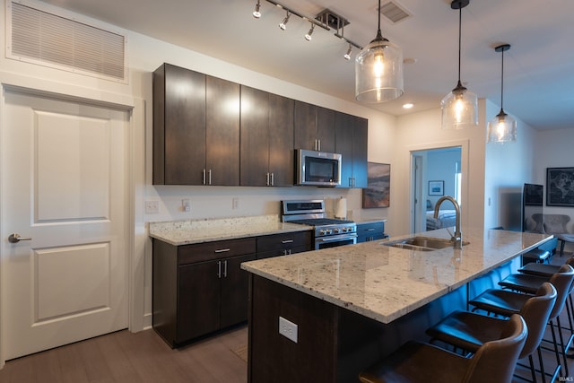 304 W Kirkwood Ave Unit 305, Bloomington, IN 47404 - kitchen featuring a kitchen breakfast bar, light wood-style flooring, visible vents, stainless steel appliances, and a sink