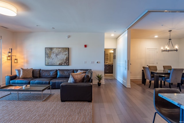 304 W Kirkwood Ave Unit 305, Bloomington, IN 47404 - living area with an inviting chandelier, visible vents, recessed lighting, wood finished floors, and baseboards