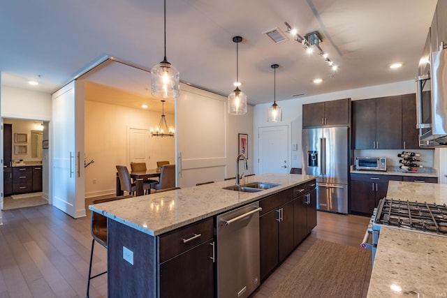 304 W Kirkwood Ave Unit 305, Bloomington, IN 47404 - kitchen with dark brown cabinetry, dark wood-style floors, visible vents, stainless steel appliances, and a sink