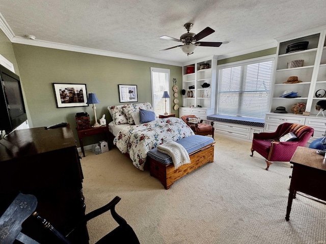 carpeted bedroom featuring a textured ceiling, ceiling fan, and crown molding