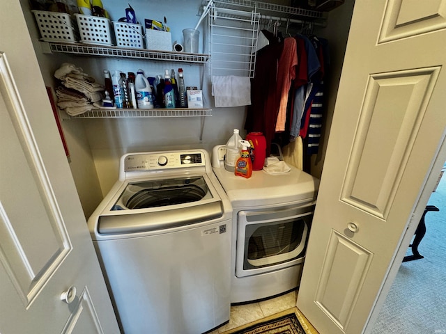 clothes washing area featuring washer and dryer and laundry area