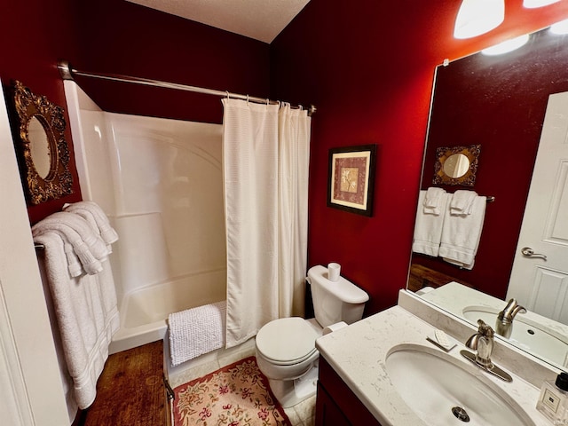 bathroom with a shower with shower curtain, toilet, and vanity