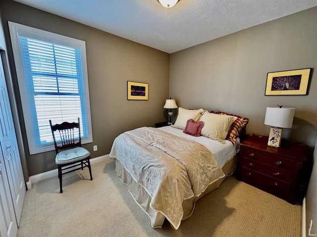 carpeted bedroom with baseboards and multiple windows