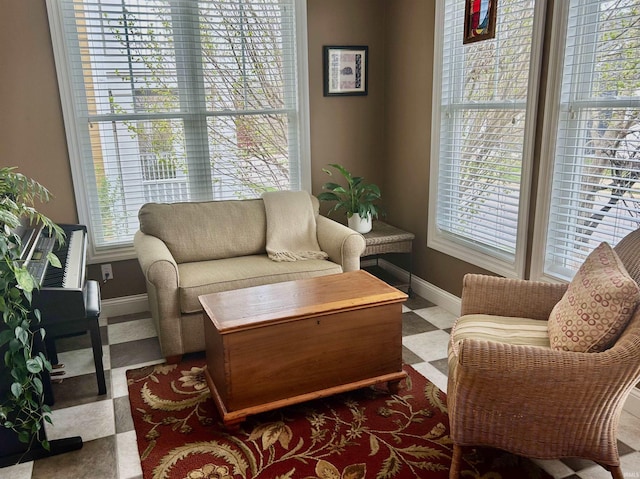 living area with plenty of natural light and baseboards