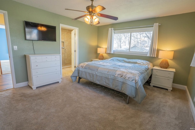 5793 E Pierce Rd, Monticello, IN 47960 - bedroom featuring baseboards, ceiling fan, ensuite bath, and light carpet