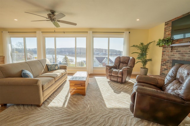 5793 E Pierce Rd, Monticello, IN 47960 - living room featuring wood finished floors, ceiling fan, a fireplace, and recessed lighting