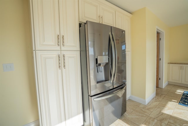 5793 E Pierce Rd, Monticello, IN 47960 - kitchen with cream cabinets, baseboards, and stainless steel refrigerator with ice dispenser