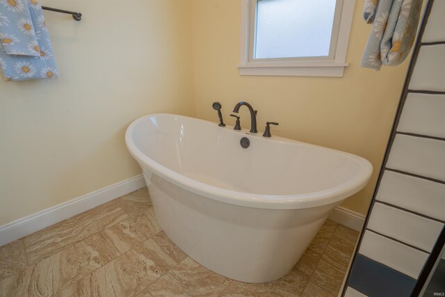 5793 E Pierce Rd, Monticello, IN 47960 - bathroom with baseboards and a freestanding tub