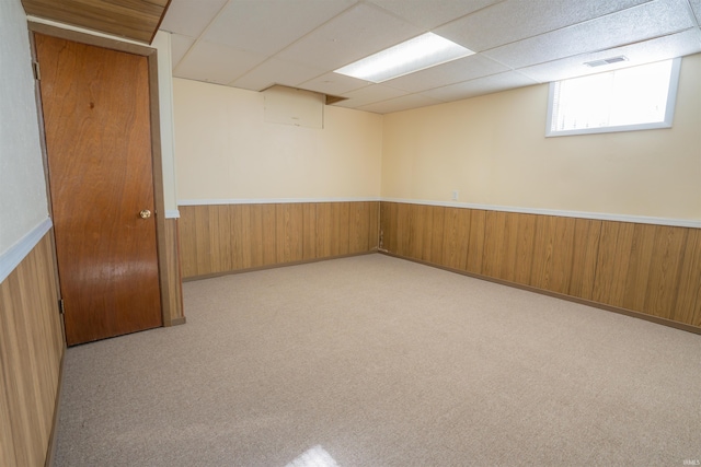 5793 E Pierce Rd, Monticello, IN 47960 - unfurnished room featuring carpet flooring, wooden walls, a drop ceiling, and a wainscoted wall