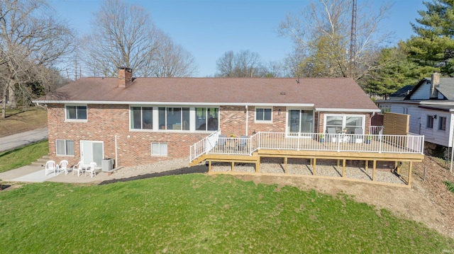 5793 E Pierce Rd, Monticello, IN 47960 - rear view of house featuring a yard, a patio area, a chimney, cooling unit, and brick siding