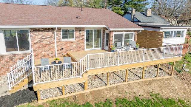 5793 E Pierce Rd, Monticello, IN 47960 - back of house with roof with shingles, brick siding, and a deck