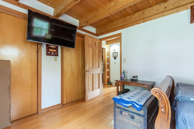 interior space featuring wooden ceiling, light wood-style flooring, and beamed ceiling