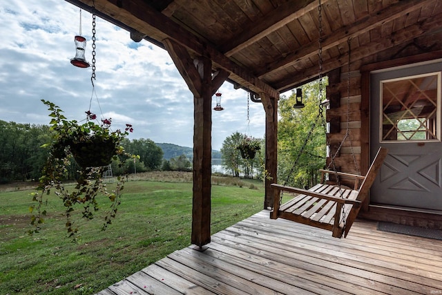wooden deck featuring a yard