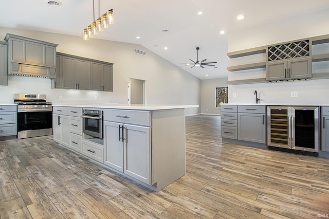 8342 S Sr 17 Hwy, Plymouth, IN 46563 - kitchen featuring open shelves, ceiling fan, appliances with stainless steel finishes, wine cooler, and gray cabinets