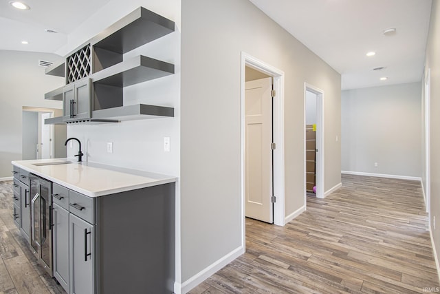8342 S Sr 17 Hwy, Plymouth, IN 46563 - kitchen with light wood-style flooring, a sink, gray cabinetry, and open shelves