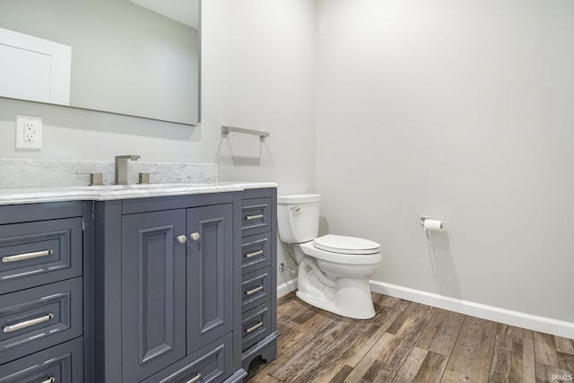 8342 S Sr 17 Hwy, Plymouth, IN 46563 - half bath featuring toilet, vanity, wood finished floors, and baseboards