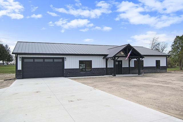 8342 S Sr 17 Hwy, Plymouth, IN 46563 - modern inspired farmhouse featuring board and batten siding, a garage, metal roof, stone siding, and driveway
