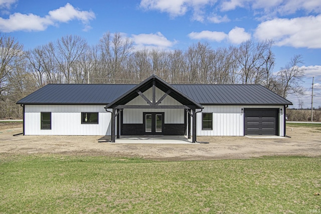 8342 S Sr 17 Hwy, Plymouth, IN 46563 - view of front of home featuring french doors, a front lawn, metal roof, and dirt driveway