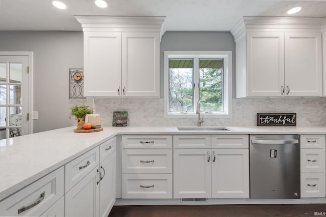 kitchen with recessed lighting, dishwasher, a sink, decorative backsplash, and white cabinetry
