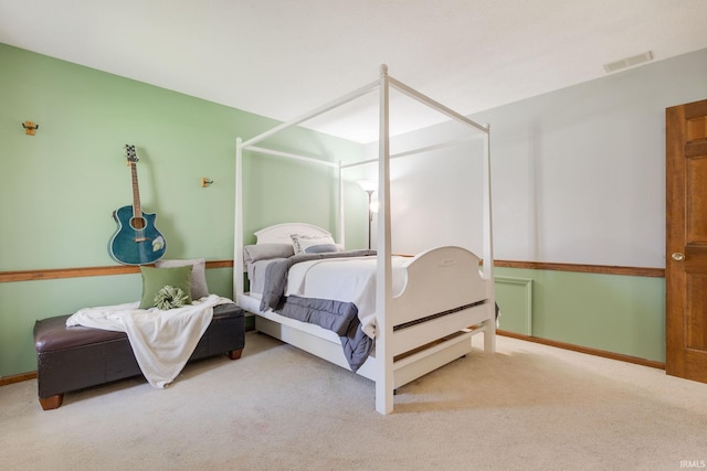 bedroom with baseboards, visible vents, and carpet