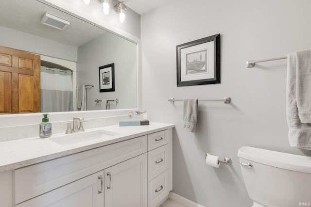 full bath with baseboards, vanity, and toilet