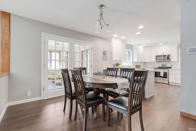 dining room with recessed lighting, wood finished floors, and baseboards
