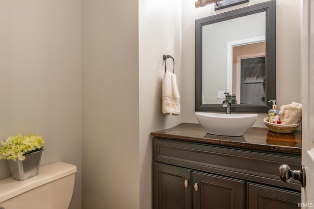 bathroom with toilet and vanity