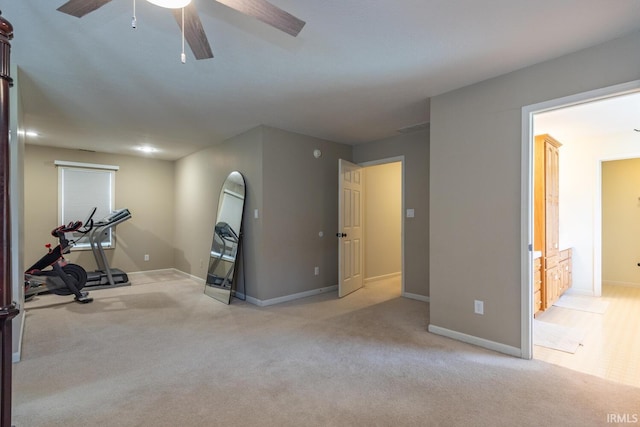 exercise room with baseboards, a ceiling fan, and carpet