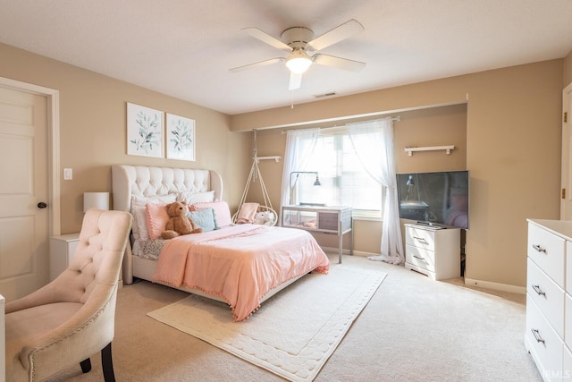 bedroom featuring visible vents, baseboards, a ceiling fan, and light carpet